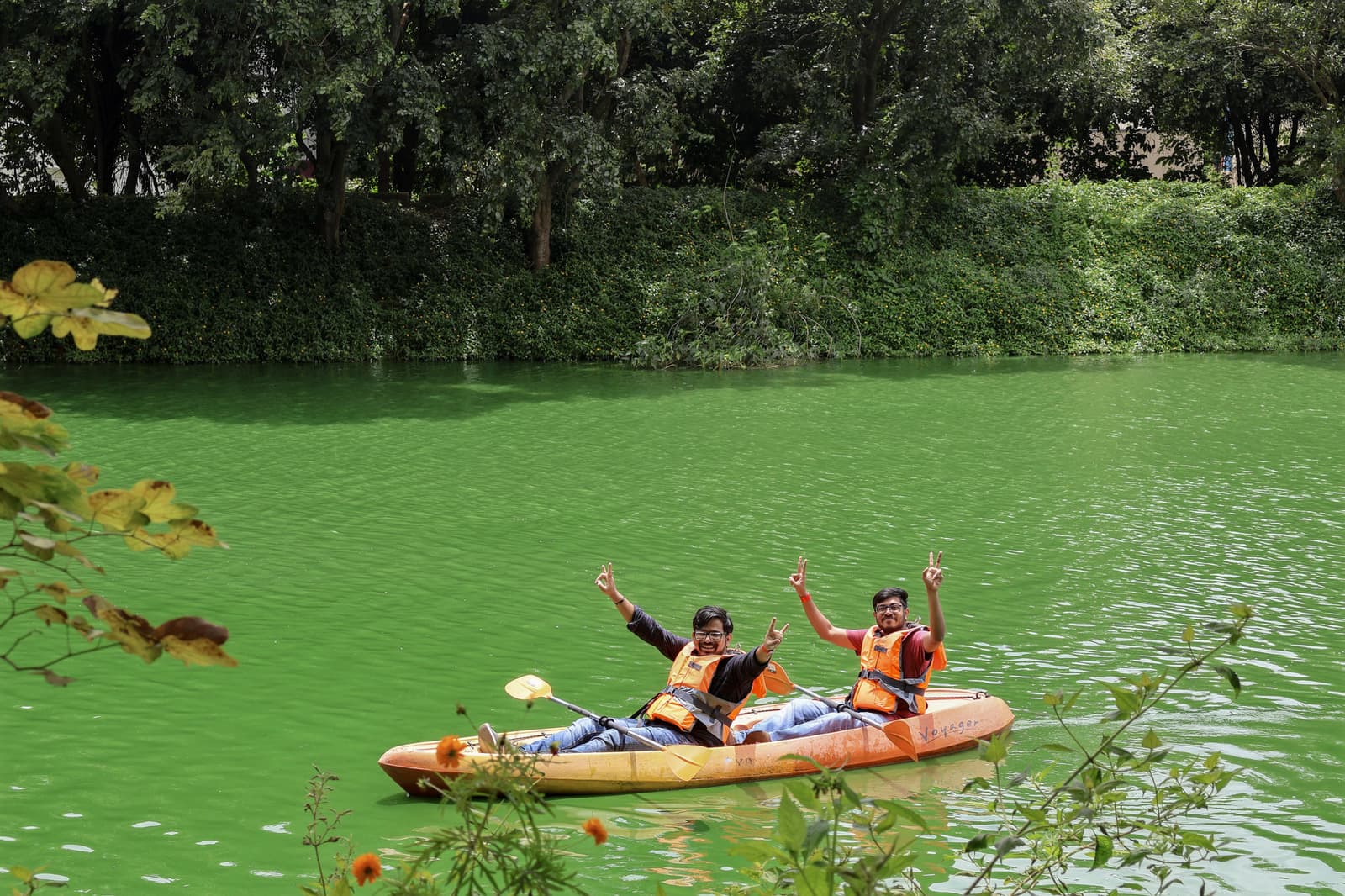 Teammates cheering from a kayak on the water