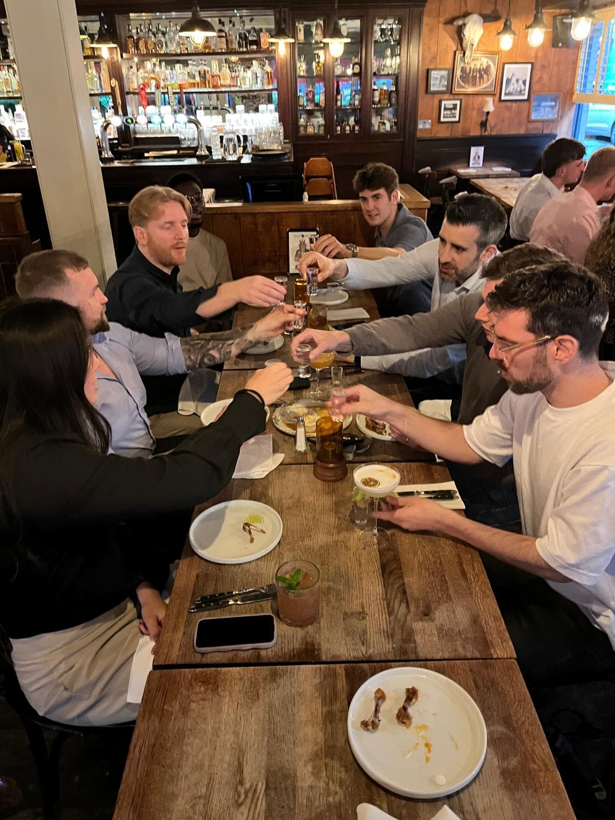 Team toasting drinks at a restaurant