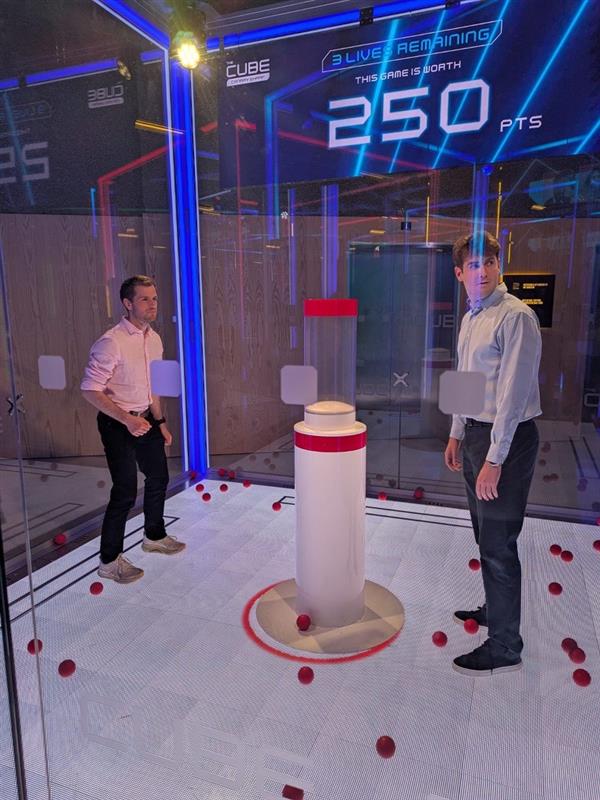 Two teammates taking on The Cube challenge