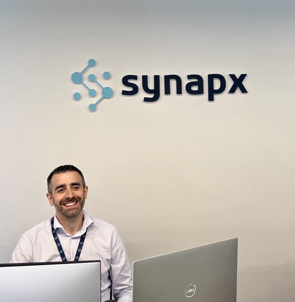 Visiting the Synapx office wall during the India trip